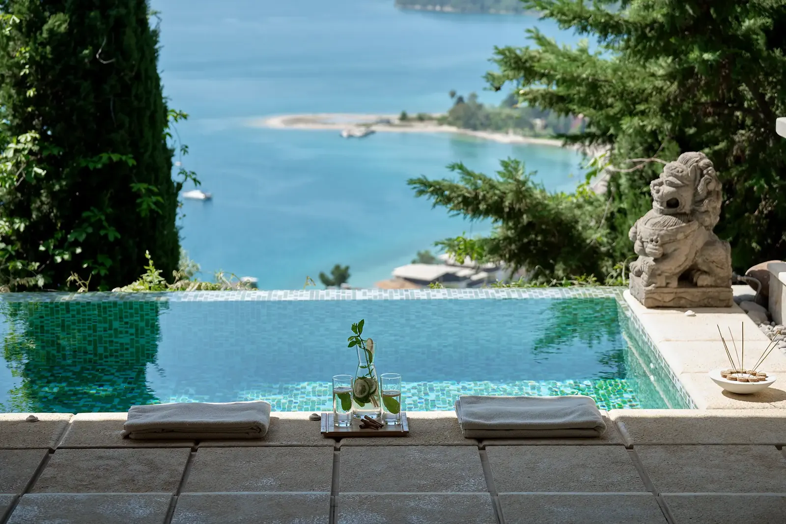 The infinity pool and a stone lion looking out to sea